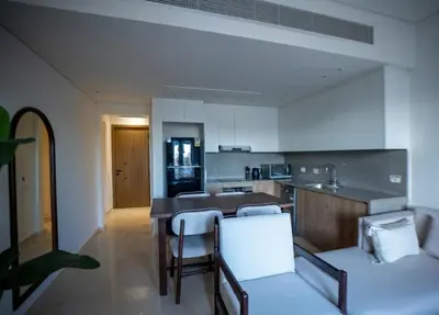 a kitchen with a table and chairs in a room at Ancient Sands El Gouna Hurghada in Hurghada