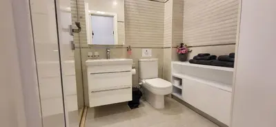 a bathroom with a toilet and a sink and a mirror at Modern studio with sea view und large roof terrace in Hurghada