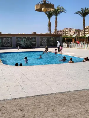 a group of people in a swimming pool at One bedroom Chalet Scandic Resort Hurghada in Hurghada