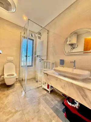 a bathroom with a shower and a sink and a toilet at Luxury 1 BR apartment with garden, Mesca - Somabay in Hurghada