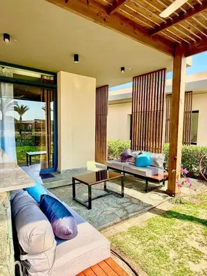 a patio with two couches and a table on a patio at Luxury 1 BR apartment with garden, Mesca - Somabay in Hurghada