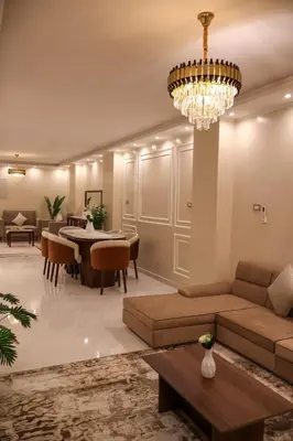 a living room with a couch and a chandelier at Cozy Luxe Apartment in Central Aswan in Aswān