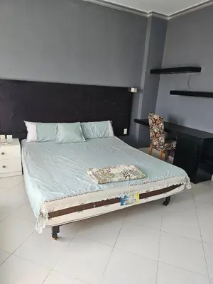 a bedroom with a bed with a black headboard at Silkes Villa in Hurghada