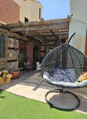 a bird cage sitting on a patio at Silkes Villa in Hurghada