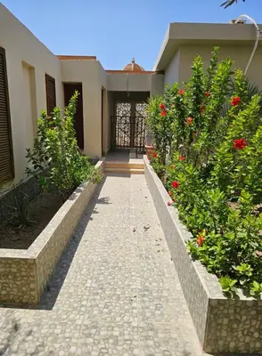 a walkway in front of a house with flowers at Silkes Villa in Hurghada