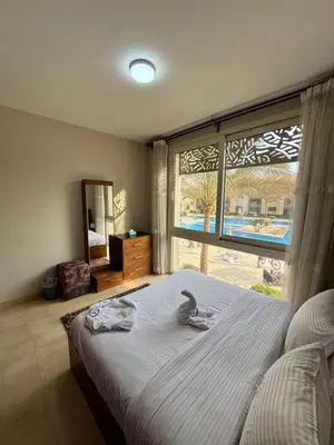 a bedroom with a large bed with a large window at Mangrove M1-5B-13 in Banī Ghālib