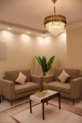 a living room with two couches and a chandelier at Cozy Luxe Apartment in Central Aswan in Aswan
