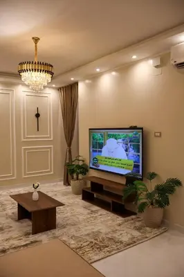 a large living room with a flat screen tv at Cozy Luxe Apartment in Central Aswan in Aswan