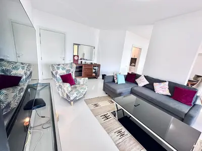 a living room with a couch and a chair at Comfortable 3BR Apartment in Swan Lake I El Gouna Ground Floor, Garden, Terrace & Lagoon Access in Hurghada