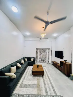 a living room with a couch and a tv at Quiet Villa in Luxor