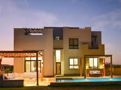 a large house with a pool in front of it at El Gouna Cyan the Range 4BDs Villa with private Pool in Hurghada