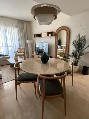 a living room with a table and chairs and a mirror at Ancient Sands Resort Gouna 1 Bedroom apartment with open view in Hurghada