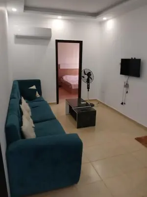 a living room with a blue couch and a mirror at Chalets 980 in Mirage resort in Hurghada