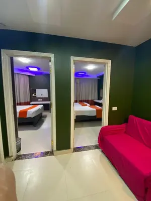 a living room with two beds and a couch at Nile Plaza Suites in Aswan