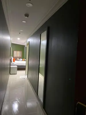 a hallway with mirrors and a bed in a room at Nile Plaza Suites in Aswan