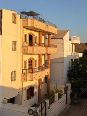 a building with a fire escape on the side of it at Luxor Old nile apartment in Luxor
