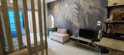 a living room with a couch and a television at Juliana Beach Resort Hurghada A105 in Hurghada