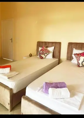 two beds sitting next to each other in a room at Karima house B in Al Aqālitah