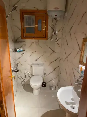 a bathroom with a toilet and a sink at Luxe Nest Luxor Serviced Apartments 301 in Luxor