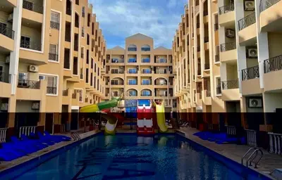 a pool in a hotel with a water slide in the middle at Juliana Beach Resort Hurghada AG10 in Hurghada