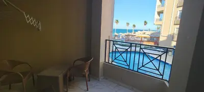 a balcony with a view of a swimming pool at Juliana Beach Resort Hurghada AG10 in Hurghada