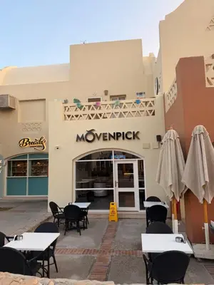 a restaurant with tables and chairs in front of a building at Casa Esmeralda in Hurghada