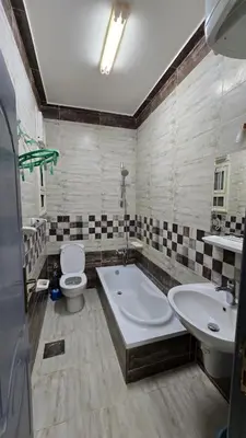 a bathroom with a tub and a toilet and a sink at Saint charbel in Hurghada