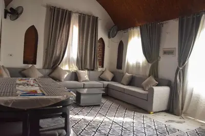 a living room with a couch and a table at Isis Magic House in Luxor