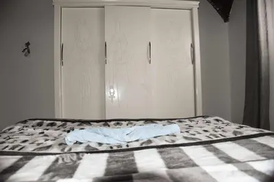a bed with a blanket on it in a room at Isis Magic House in Luxor
