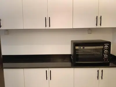 a microwave oven sitting on top of a kitchen counter at فلورانزا خمسين b06 in Hurghada