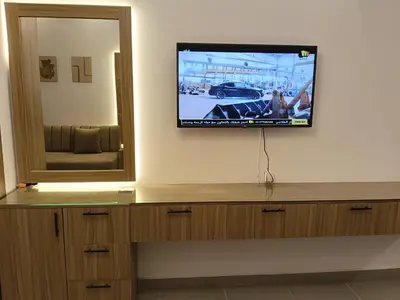 a flat screen tv on a wall next to a mirror at فلورانزا خمسين b06 in Hurghada