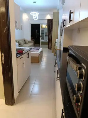 a kitchen and a living room with a couch at فلورانزا خمسين b06 in Hurghada