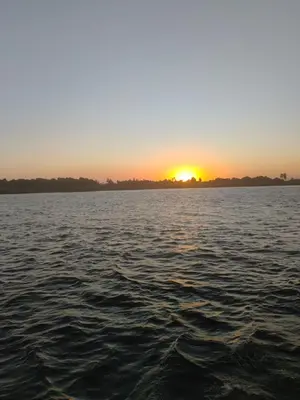 a sunset over a large body of water at Nile SE Felucca nile cruise private tour in Naj‘ al ‘Amrāb