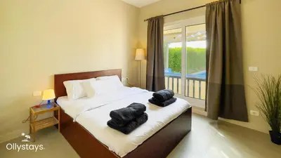 a bedroom with a bed with towels on it at Ollystays Joubal Lagoon 3BR Villa Heated Pool in Hurghada