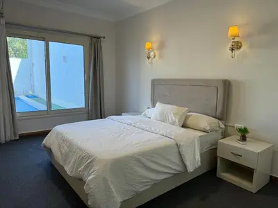 a bedroom with a large bed and a window at Luxury Red Sea Villa in Hurghada