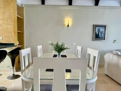 a dining room with a white table and chairs at Luxury Red Sea Villa in Hurghada