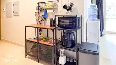 a kitchen with a microwave oven and a microwave at Ollystays Mangroovy 2 BR Beach and Pool Free access in Hurghada