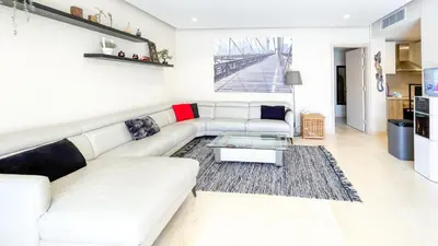 a living room with a white couch and a coffee table at Ollystays Mangroovy 2 BR Beach and Pool Free access in Hurghada