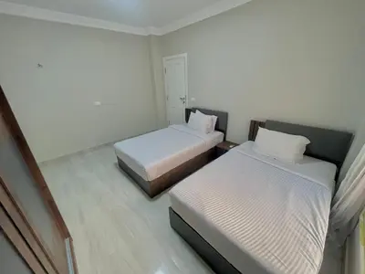 a small room with two beds and a bedskirts at Elegant one bedroom apartment managed by Lilly Homes in Hurghada