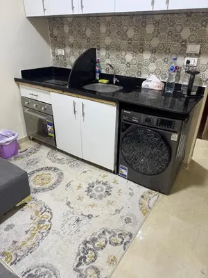 a kitchen with a stove and a dishwasher at Casablanca star hurghada in Hurghada