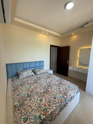 a bedroom with a large bed with a blue head board at Casablanca star hurghada in Hurghada