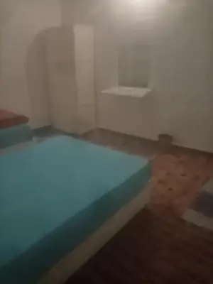 a white room with a bed and a wooden floor at New senger tood in Naj‘ al ‘Amrāb