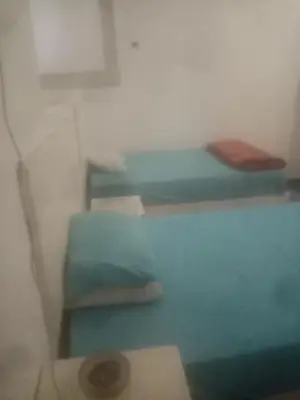 a small room with a bed and a shelf at New senger tood in Naj‘ al ‘Amrāb