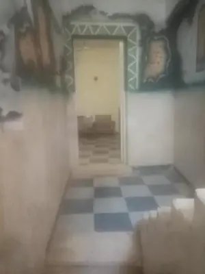 a room with a door and a checkered floor at New senger tood in Naj‘ al ‘Amrāb