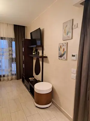 a living room with a stool in a room at Alday gorizont in Hurghada