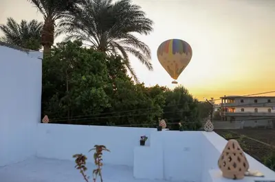a hot air balloon flying in the sky over a building at Akhet House in Luxor