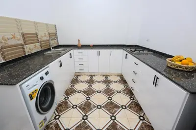 a kitchen with a sink and a washing machine at Akhet House in Luxor