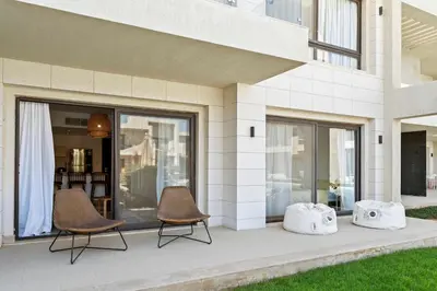 two chairs sitting on a patio in front of a building at The G Cribs Sunlit - El Gouna in El Gouna