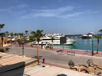 a marina with a boat in the water at New Marina Deluxe in Hurghada
