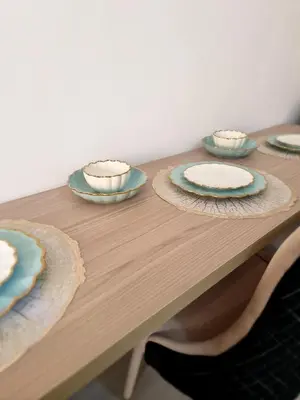 a wooden table with blue and white plates on it at Oasya Studio Hurghada in Hurghada